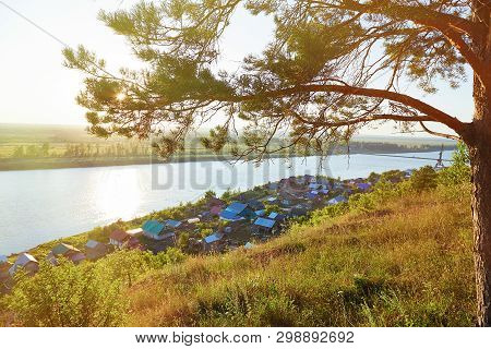 View Of Houses Near The White River Respublika Bashkortotan, Russia In The Backlight Of The Sun