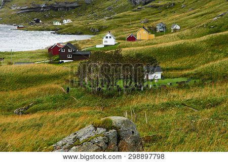 Man Hiking To The Village Vinstad Next To A Graveyard On Lofoten Islands In Norway.
