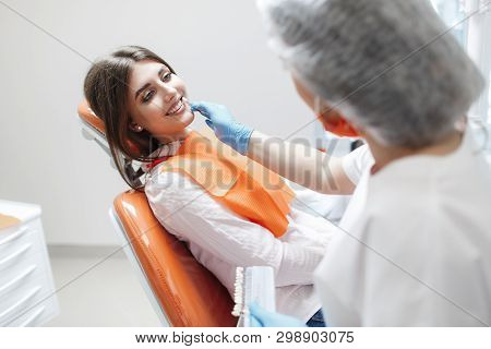 Dental Clinic. Reception, Examination Of The Patient. Teeth Care. Young Woman Undergoes A Dental Exa
