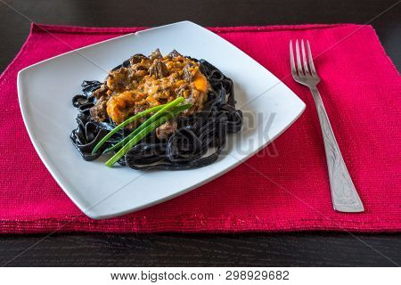 Black Pasta With Cuttlefish Ink. Pasta Of Durum Wheat Semolina With Squid Ink With Beef And Sweet Pe
