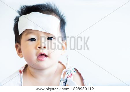 Unhappy Asian Little Baby Sick With Cool Fever Jel Pad On Forehead