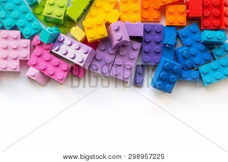 A Lot Of Colorful Plastick Constructor Blocks On White Background. Popular Toys. Copyspace