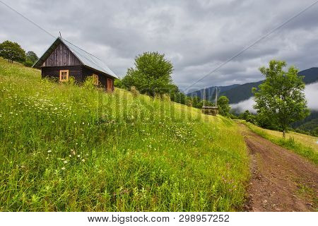 Summer Mountain Panorama. Small Wooden House Cottage And Barn On Green Mountain Valley On Bright Fog