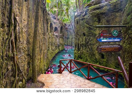 XCARET,MEXICO - APRIL 16,2019 : Visitors enjoying the underground river at the XCaret park on the Mayan Riviera