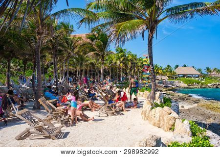 XCARET,MEXICO - APRIL 16,2019 : People relaxing at the beach on the XCaret park on a beautiful sunny day