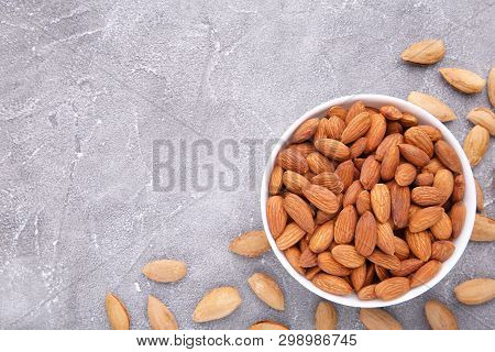 Bowl Of Almonds On A Grey Background