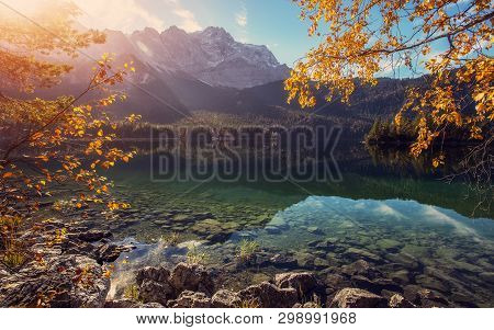 Impressive Autumn Landscape The Eibsee Lake In Front Of The Zugspitze Under Sunlight. Amazing Sunny 