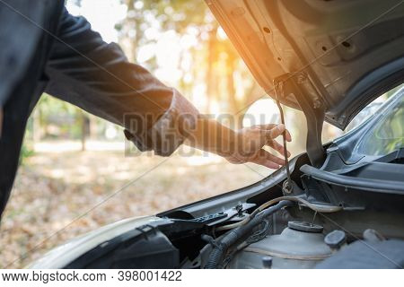 Close Up Hand Man Open Car Hood For Repair As Maintenance Service. Man Trying To Repair A Car Engine