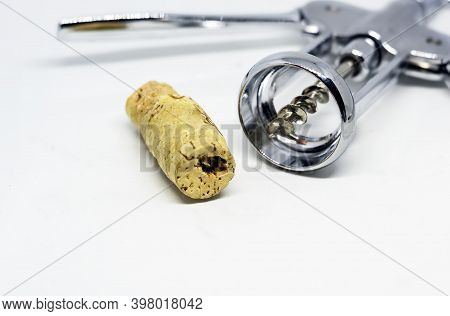 Steel Wing Corkscrew With A Perforated Cork Isolated On A White Background.