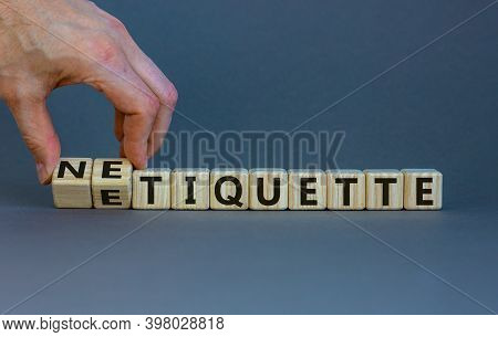 Etiquette Or Netiquette. Male Hand Turns Cubes And Changes The Word 'etiquette' To 'netiquette'. Bea