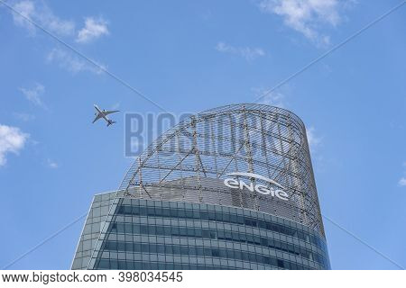 Paris, France - Jun 13, 2020: Plane Fly Over Tour T1 Engie Skyscraper In La Defense