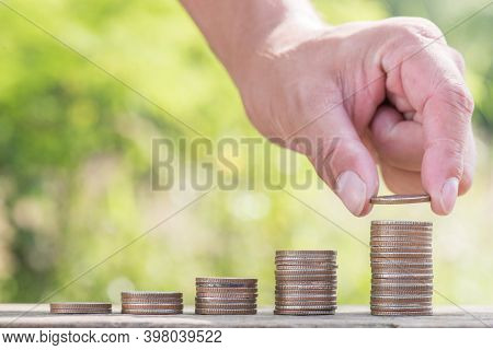 Hand Putting Money Coin Stack Growing Business,finance And Money Concept,hope Of Investor Concept