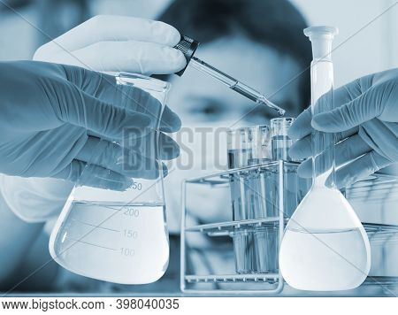 Conical Flask In Scientist Hand With Lab Glassware Background, Laboratory Research Concept