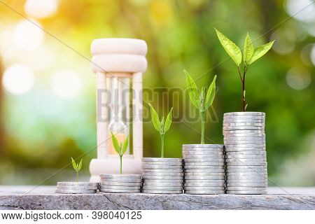 Close Up Of Stacking Gold Coins With Green Bokeh Background ,business Finance And Money Concept,save