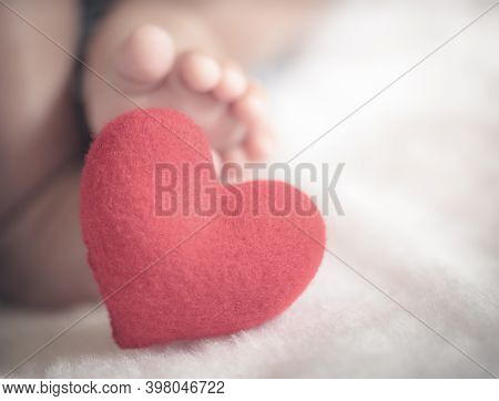 Baby's Feet With A Red Heart In Vintage Tone Style