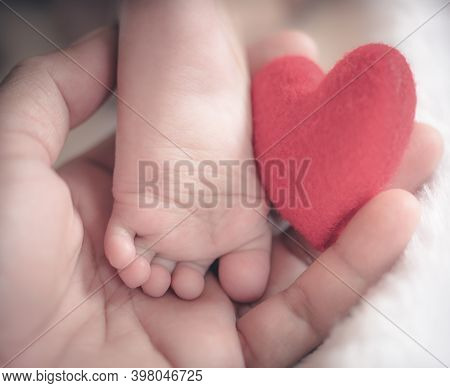 Baby's Feet With A Red Heart In Vintage Tone Style