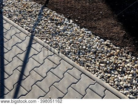 Delivery Of Gray River Pebbles Like Mulch To Flower Beds In The Garden Using A Wheelbarow From The B