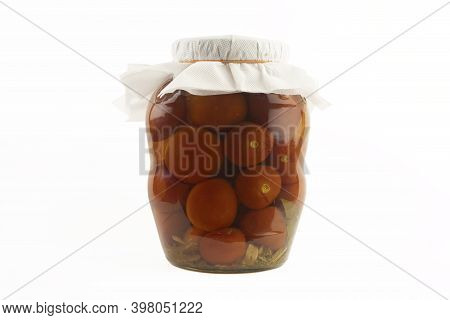 Glass Jar With Pickled Tomatoes On A White Background.