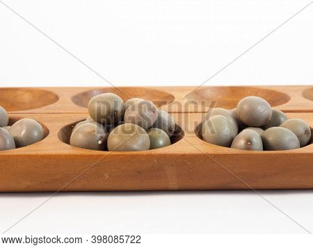 A Traditional African Wooden Game With Seeds, The Awale. Concept Around Play And Tradition.