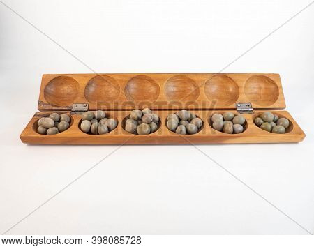 A Traditional African Wooden Game With Seeds, The Awale. Concept Around Play And Tradition.