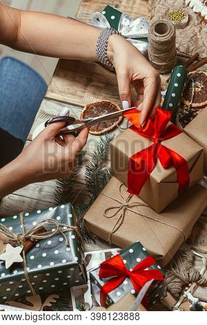 Young Woman Wrapping And Decorates A Lot Of Stack Of Gifts Chri