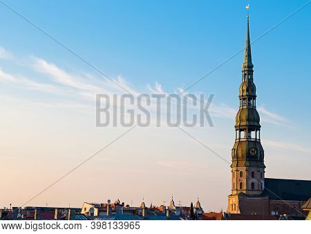 Symbol Of Riga, Old Clock On Medieval Church Tower Among Roofs Ancient Buildings With European Archi