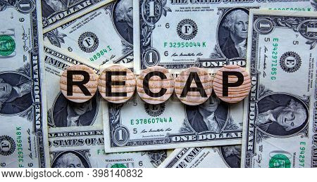 Recap Symbol. Wooden Circles With Word 'recap' On A Beautiful Background From Dollar Bills, Copy Spa