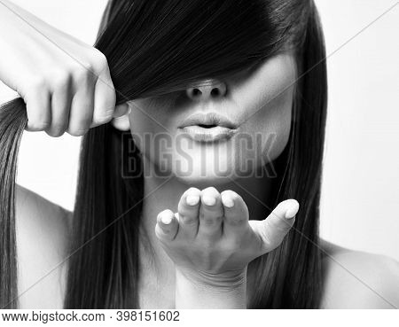 Portrait Of Young Pretty Woman Model With Silky Long Straight Hair Holding Strand And Sending Air Ki