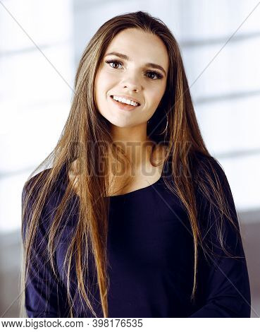 Beautiful Young Business Woman With Long Hair Or Female Student Urban Dressed Is Standing Straight A