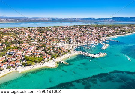 Town Of Pakostane On Adriatic Sea Coast In Croatia And Vransko Lake In Background, Aerial View