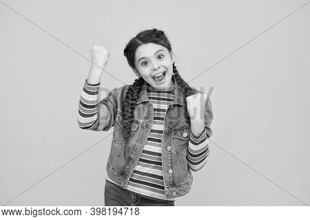 Always A Winner. Happy Little Winner Yellow Background. Small Girl Make Winner Gesture. Celebrating 