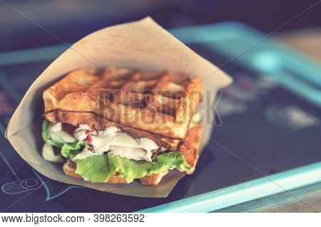 Sandwich In A Paper Bag Close-up. Sandwich Filet Americain, Close Up Of Burger. Fast, But Unhealthy 