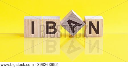 Iban Word Is Made Of Wooden Building Blocks Lying On The Yellow Table, Concept