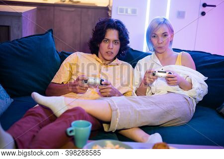 Handsome Young Man Teaching How To Play The Video Games To His Girlfriend, On The Couch, Concept Abo