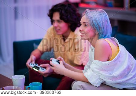 Handsome Young Man Teaching How To Play The Video Games To His Girlfriend, On The Couch, Concept Abo