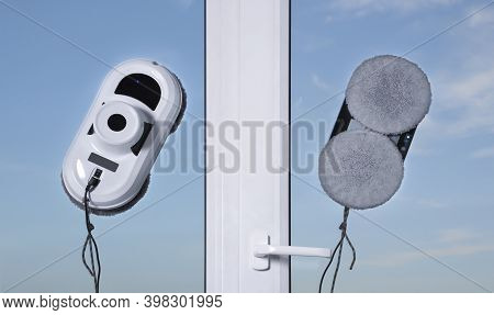 Downside Of Vacuum Cleaner Robot For Washing Glass Window On Clean Blue Sky Background. Robot Assist