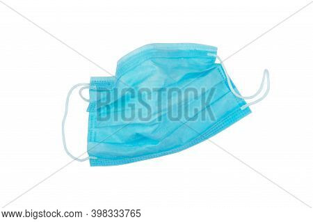 Used Blue Medical Nonwoven Fabric Face Mask With Elastic Ear Loops Isolated On White. Plastic Pollut