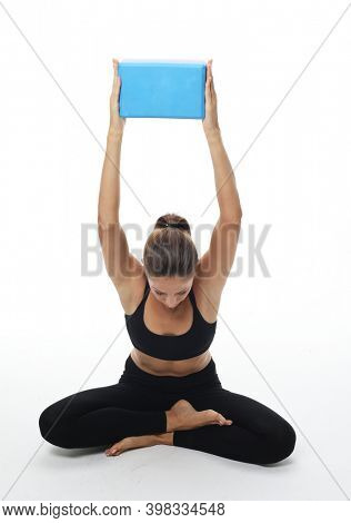 Yoga and fitness concept:Woman practicing yoga with yoga block over white background