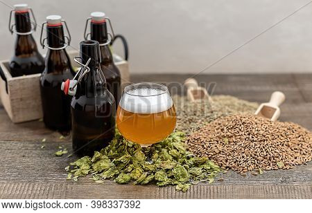 Craft Pale Ale In A Glass With Beer Growlers And Green Dry Hops. Home Brewing. Copy Space.