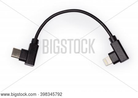 Short Cable With Plugs Usb Type-c And Lightning At The Edges On A White Background, Top View