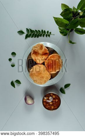 Delicious And Tasty Homemade Poori Placed On A Plate With White Background