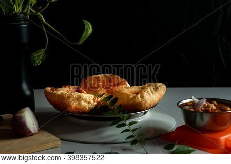 Delicious And Tasty Homemade Poori Placed On A Plate With Black And White Background With Selective 