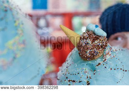 Child Eating Sweets And Candy On A Huge Cotton Candy Floss With Ice Cream And Dessert Sauce