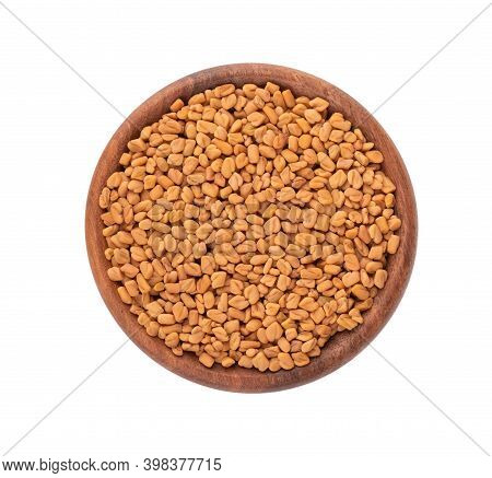 Fenugreek Seeds In Wooden Bowl, Isolated On White Background. Shambala, Helba Seeds. Top View.