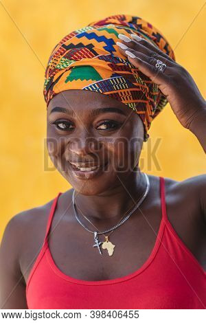 Happy African Woman With A Yellow Wall In The Background In The Small Village Of Keta Located In Gha