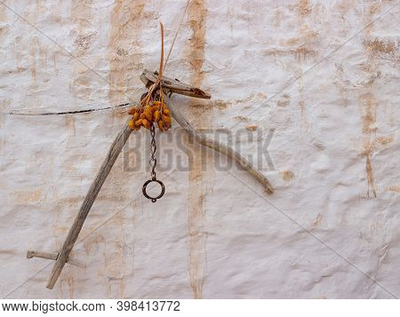 Dried Dates And Old Shackled Against A Wall In Troglodyte Cave-dwelling. Life And Lifestyle Of The B