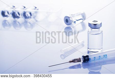Single Use Syringe For Injection Treatment On Medical Table With Vials Of Liquid Drug Doses Flu Shot