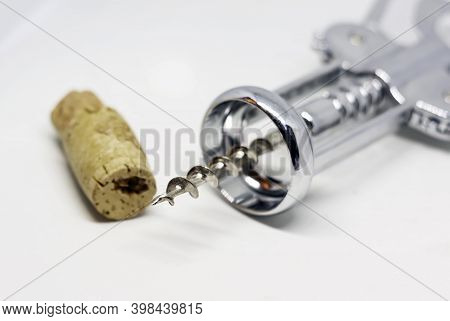 Steel Wing Corkscrew With A Perforated Cork Isolated On A White Background.