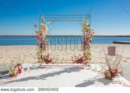 Event Decoration. Wedding Chuppa At Riverside Decorated With Fresh Flowers. Florist Workflow