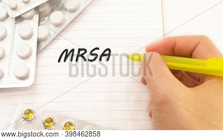 Text Mrsa On White Background. There Are Various Pills And Vitamins Around. Medical Concept